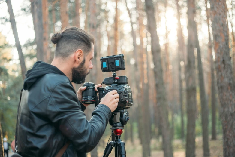 the man is shooting soing in the forest