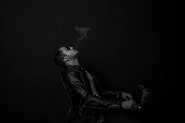 a black and white po of a man smoking