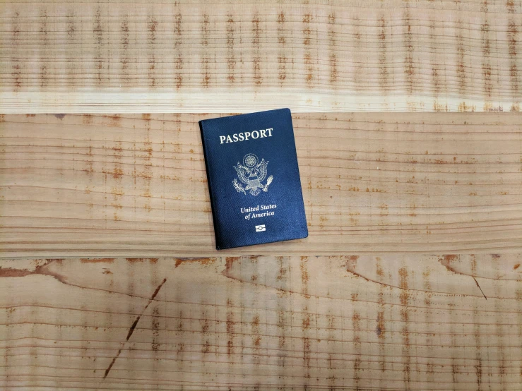 an american passport placed on a wood table