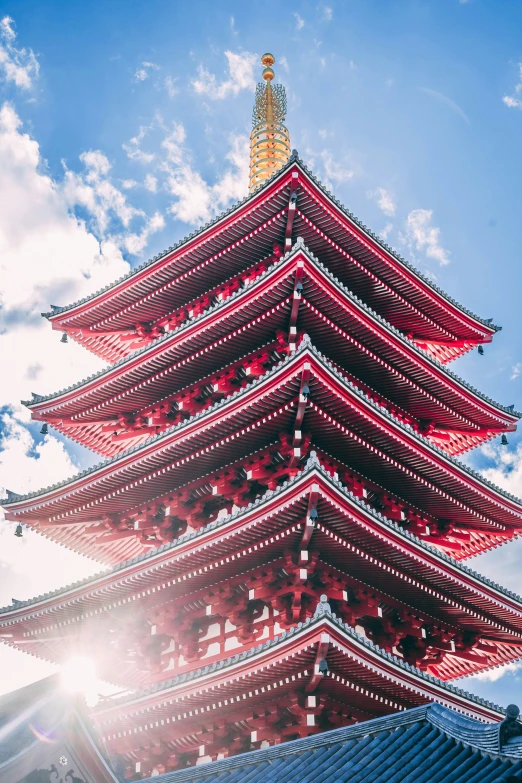 a tall red tower towering over a blue sky