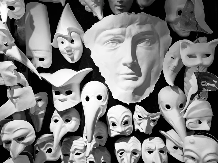 a large assortment of masks are arranged together