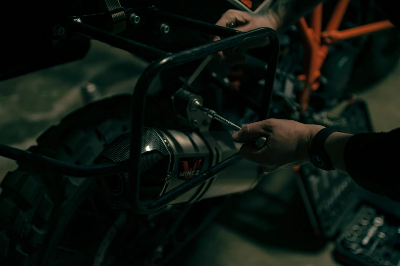 a man with a wrench working on a car