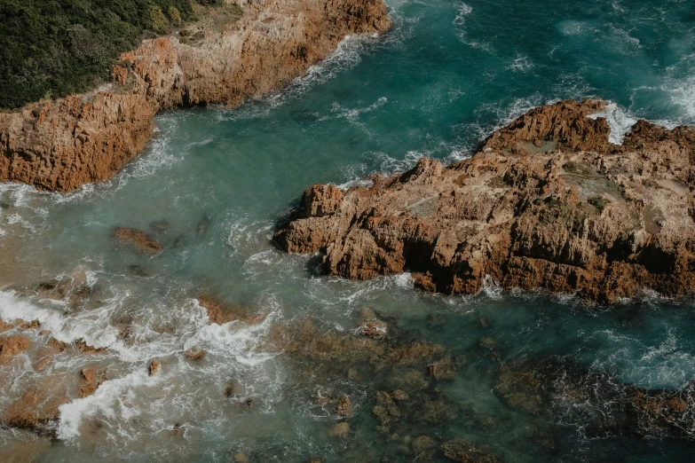 top view of rocky coastline near water and waves