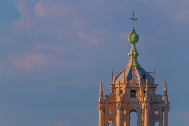 a tall cathedral building with a cross on the top