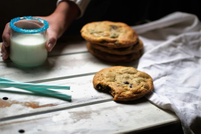 some cookies and milk are on the table