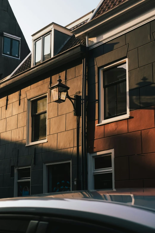 an apartment building with windows is shown from the street