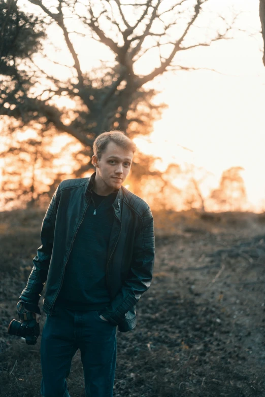 young man in a black jacket walking away from the camera