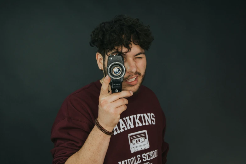 a man holds up his camera while taking a picture