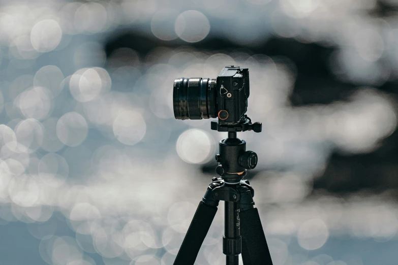 a camera on a tripod on a tripod with a blurred background