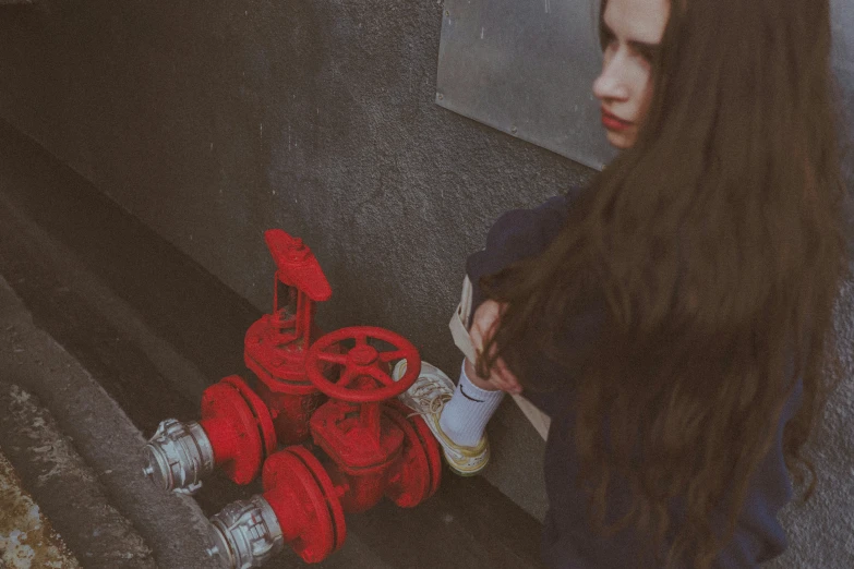 woman holding soing and standing next to fire hydrant