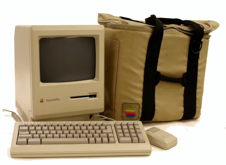 an old computer with a storage bag and keyboard
