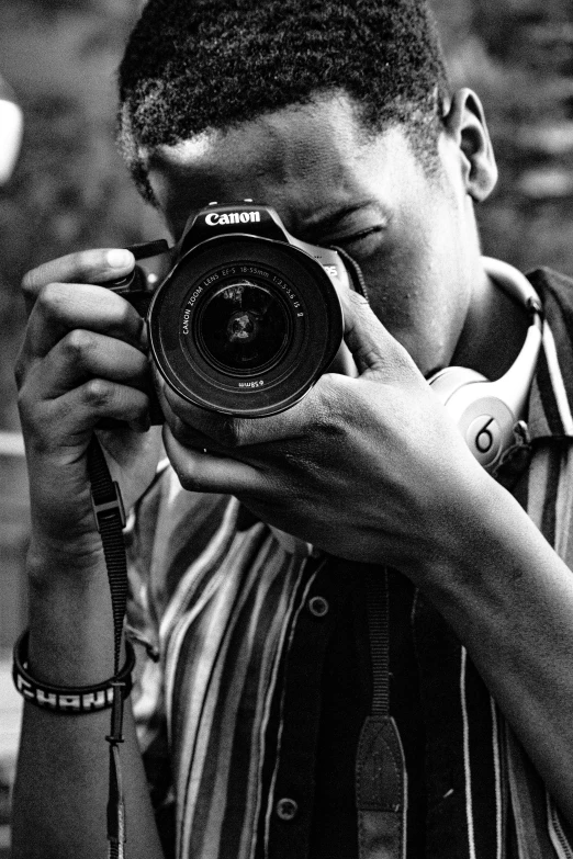 black and white pograph of young man with a camera