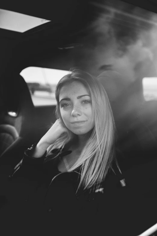 a woman in the back seat of a car