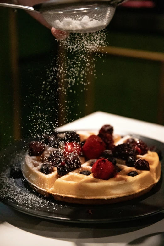 a cake is topped with berries, berries and sugar