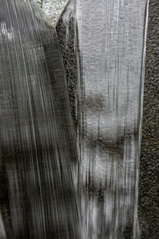 water pouring from the top of a large body of water