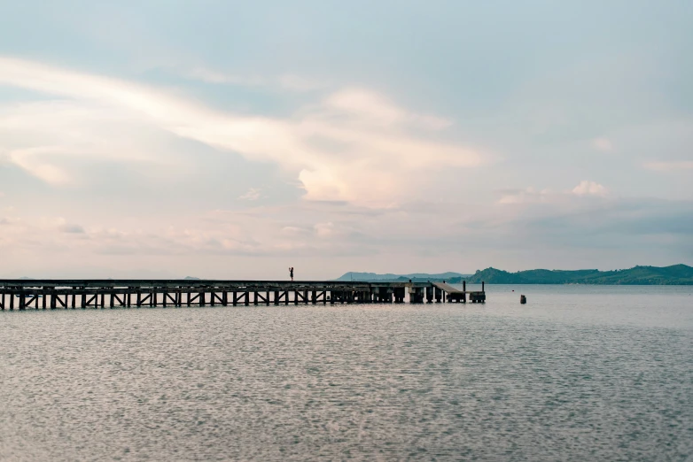 a large wooden pier on top of the ocean