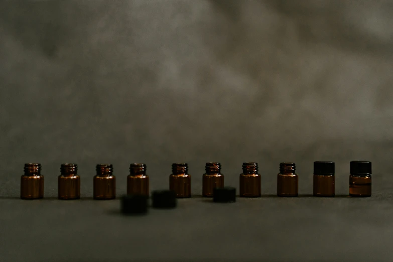 bottles with brown caps in a row next to one another