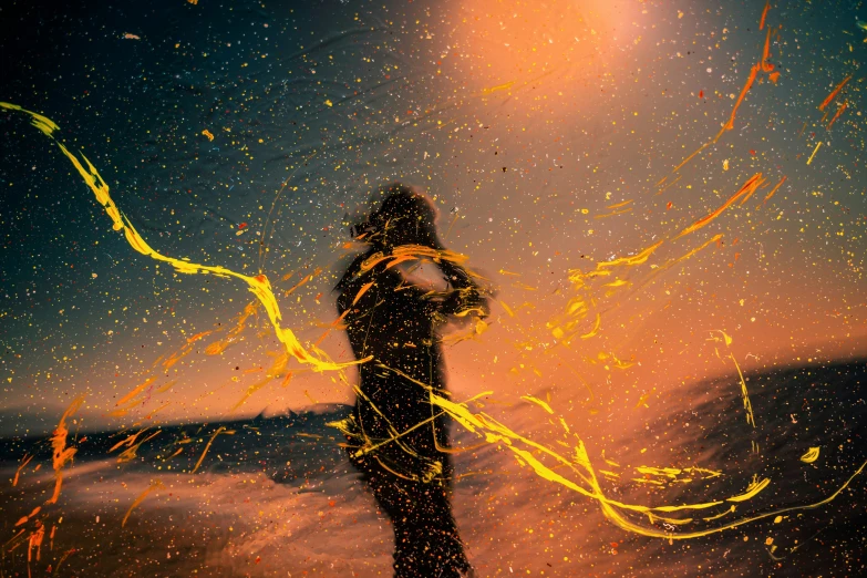 a man standing on a beach near the ocean