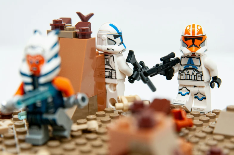 legos holding guns and wearing white uniforms, with brown bricks