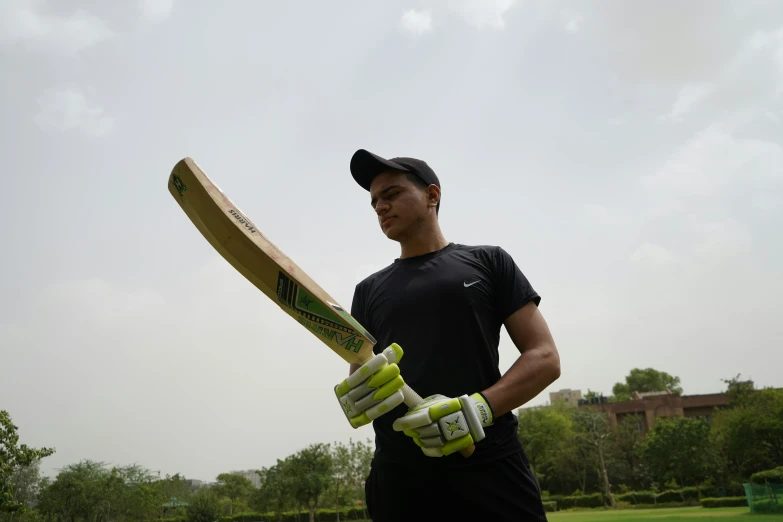 a man holds a bat in his hands