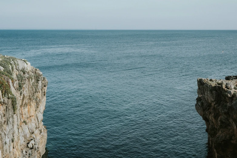 a large cliff sticking out into the ocean