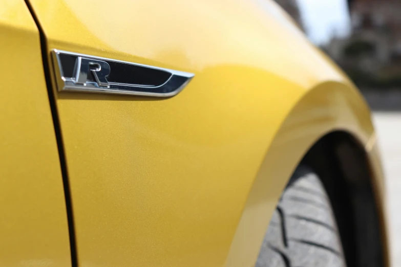 an emblem on the side of a yellow car