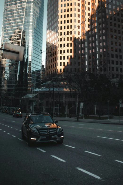 a car driving through the center of city streets