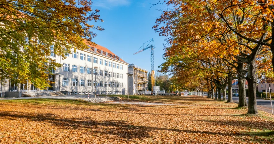 a large building with lots of trees around it