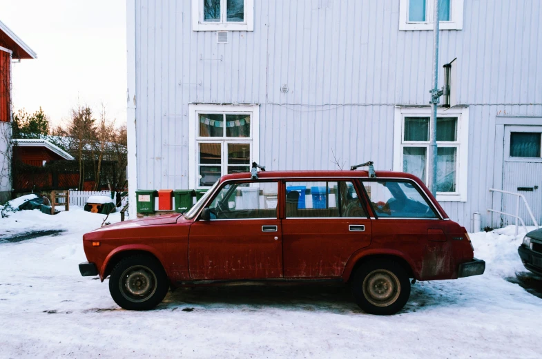 a small red car sits in front of the building