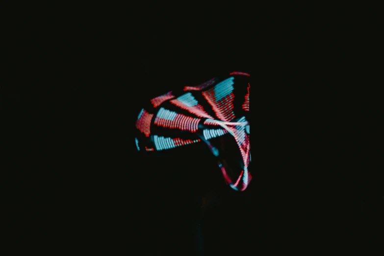 a black background with a bright lit object in the dark