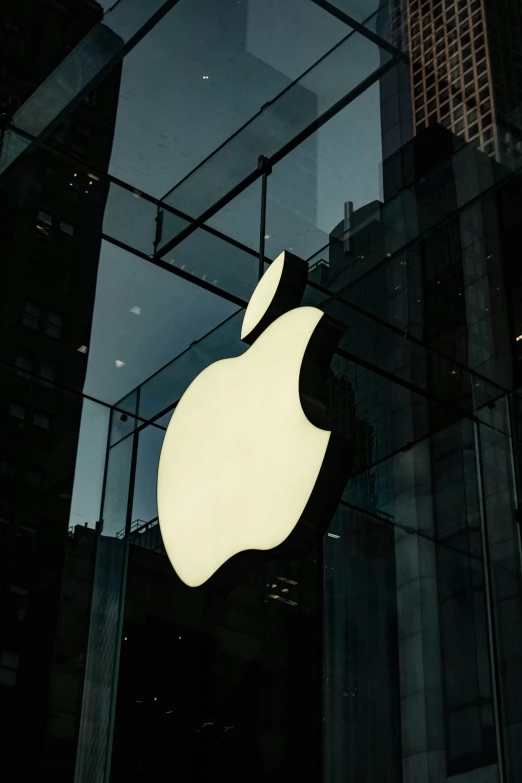 an apple logo hanging on the side of building