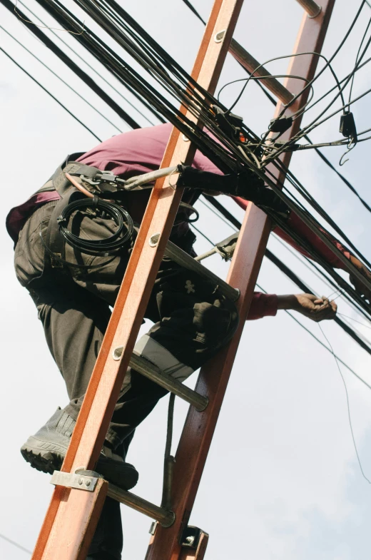 a man in safety gear is climbing a ladder