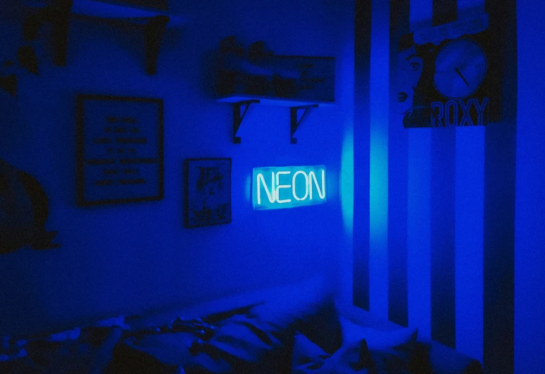 a very bright neon sign sitting in the corner of a room