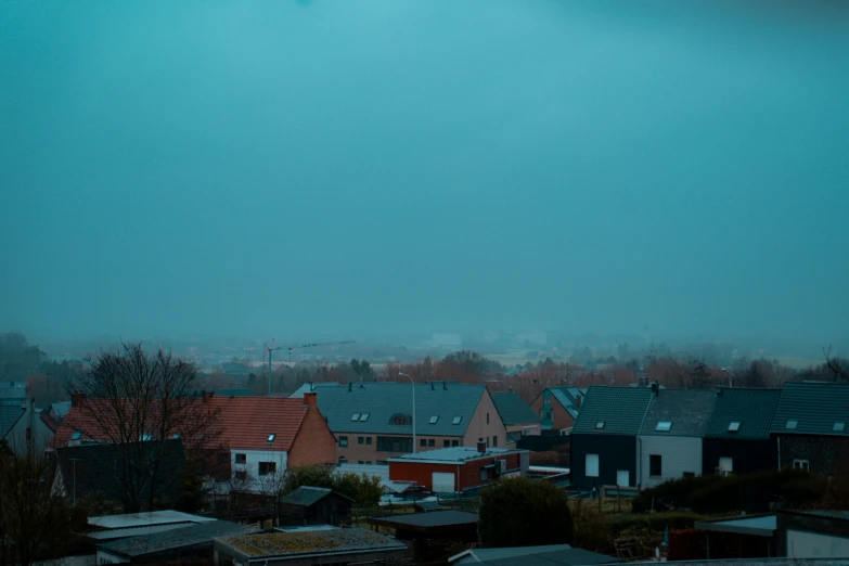 a row of houses sit on a hill overlooking the countryside