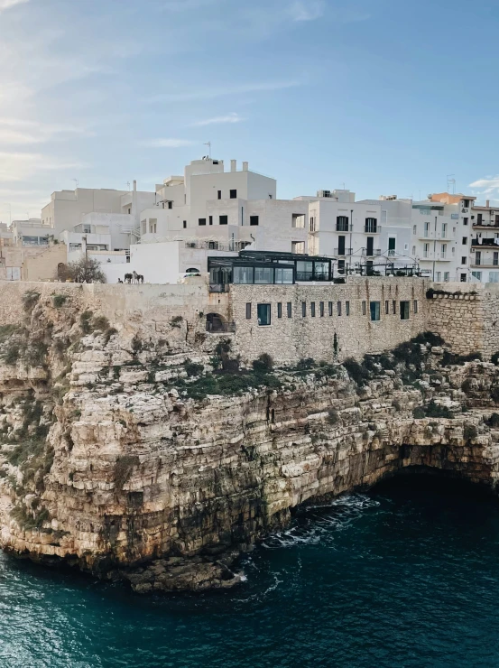 an island with buildings and blue water on it