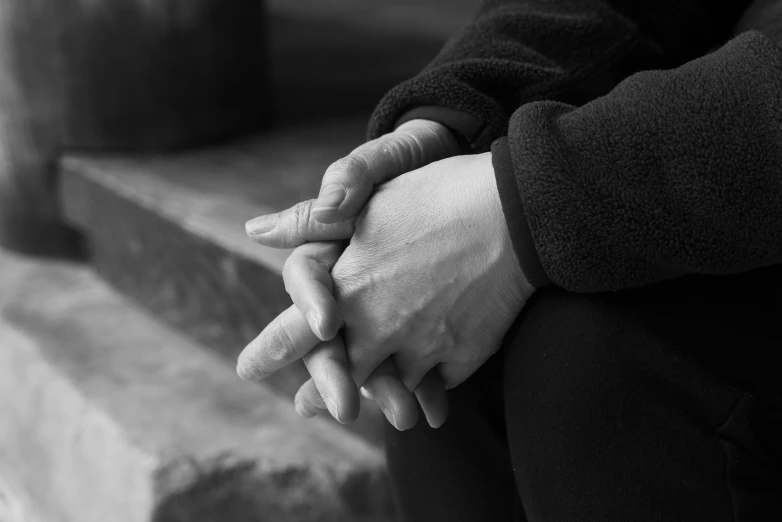 a black and white po of two hands touching each other