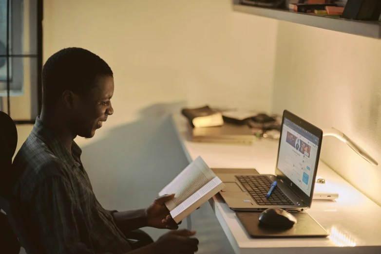 a person sitting at a desk with a laptop