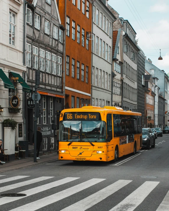 a yellow bus parked at a street curb