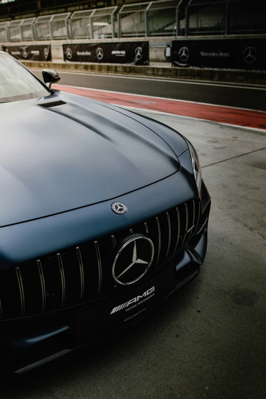 a black sports car on track with another car in the background