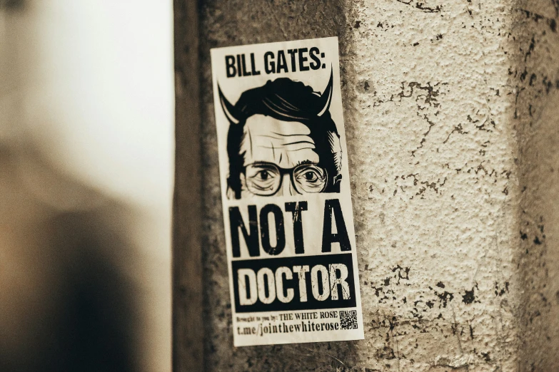 a poster on the side of a building with an image of a man in glasses