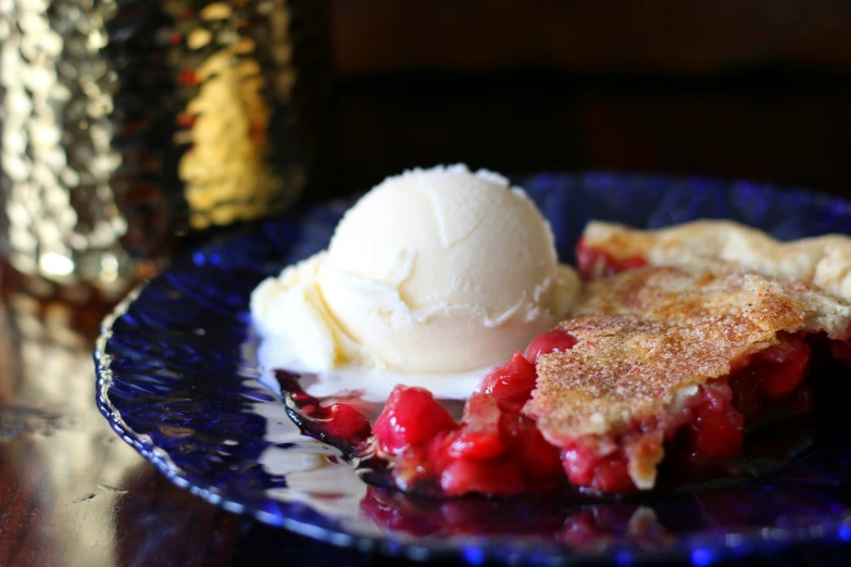 a plate with a slice of fruit and ice cream