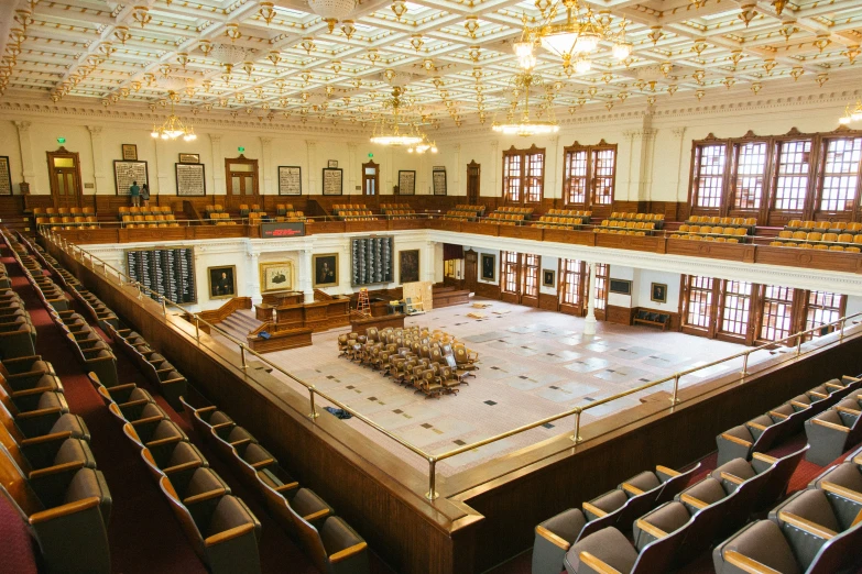 this is a large room with lots of wooden chairs