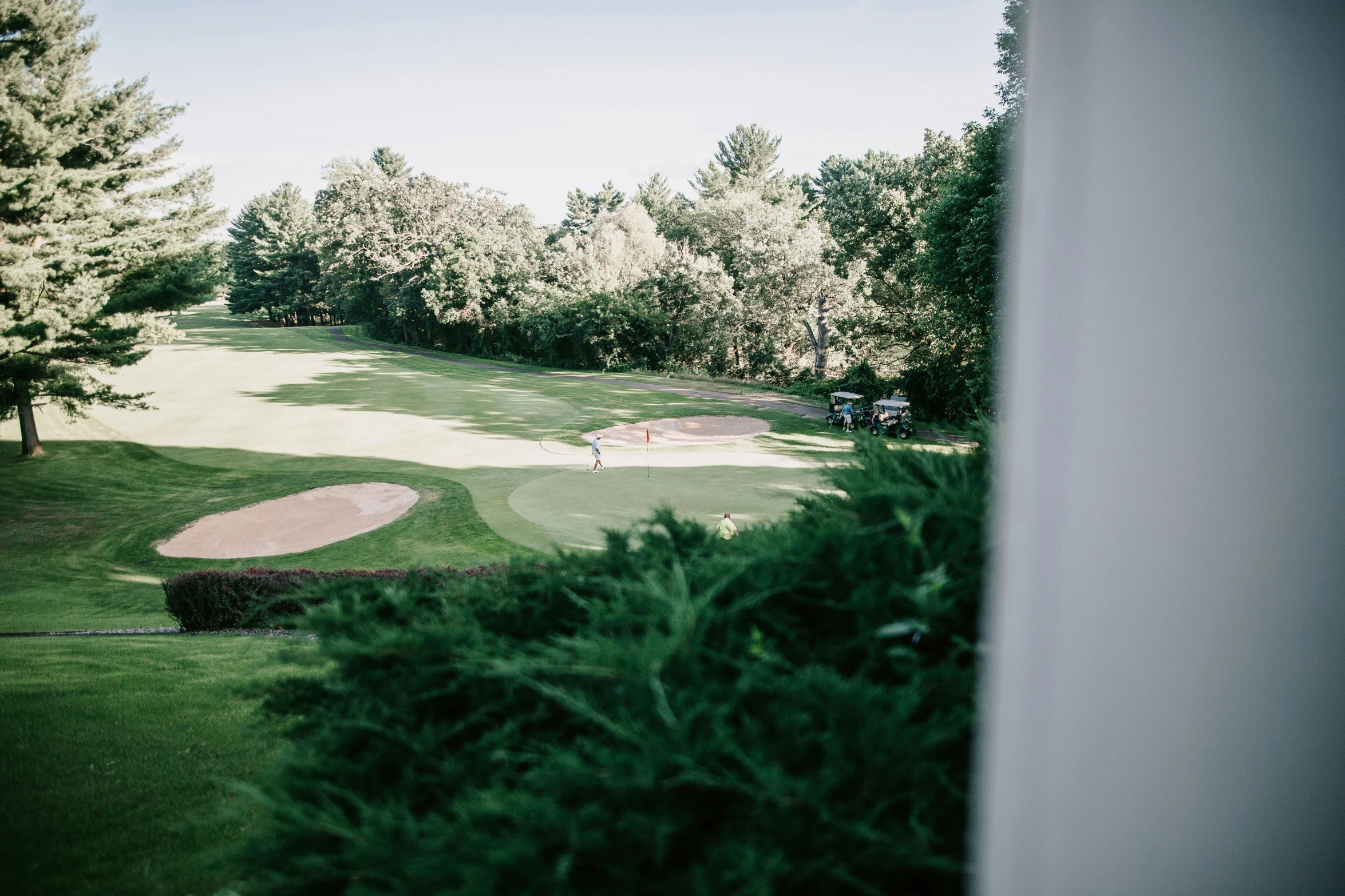 an aerial view from a golf course with trees around it