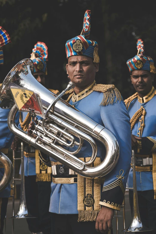 men in uniform are playing music with their instruments