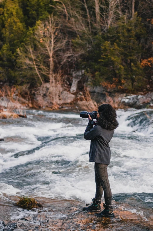 a woman looking up into the sky with a camera