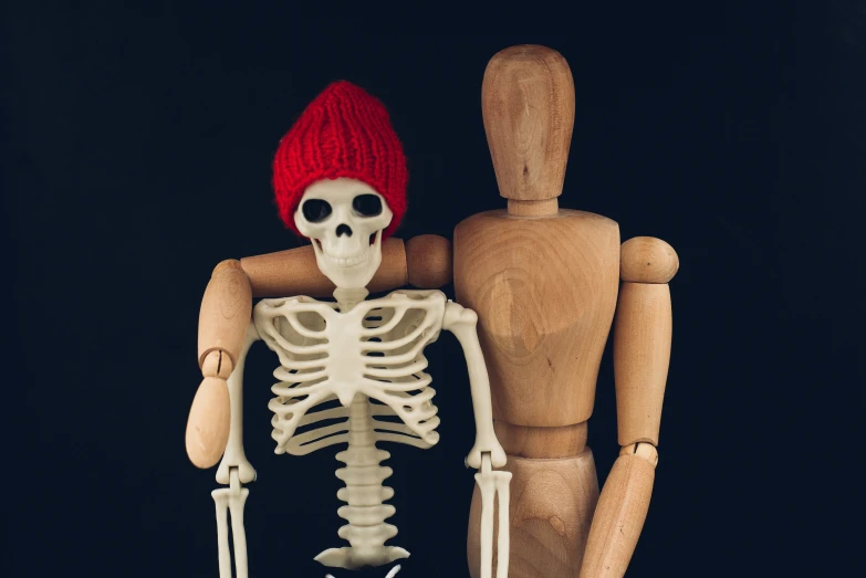 a skeleton wearing a red hat on its head