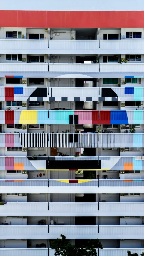 a multi - colored building with several windows and balconies