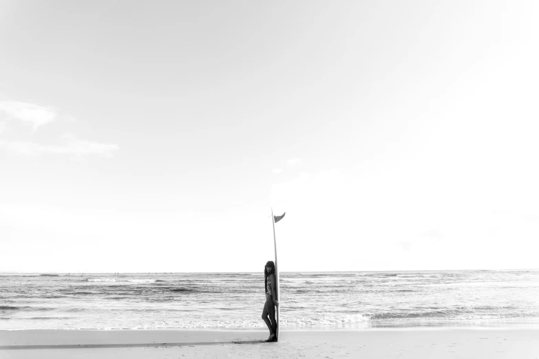 the beach is empty with a flag pole in the sand