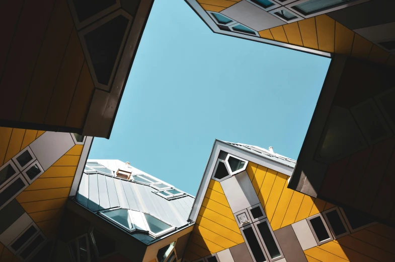 some buildings and windows that are reflecting the sky