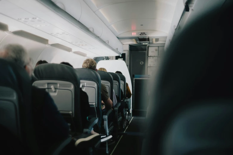 passengers in the passenger aisle of an airplane